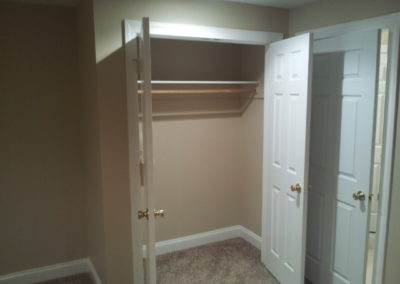 Closet- beige walls, beige carpet, white doors.