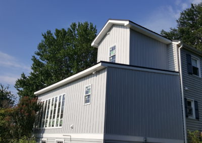 Exterior view of home addition, white siding (view 2).