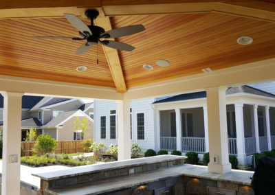 Covered BBQ and seating with ceiling fan (view 2).