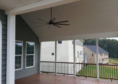 Covered deck with columns, upward view of ceiling fan (view 5).