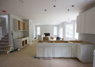 Kitchen being built- white walls, white cabinets, no counters, no appliances
