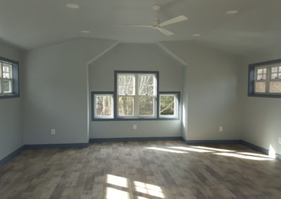 DeWall Garage View 4, Interior. Light blue walls, dark blue trim around windows, wood flooring.