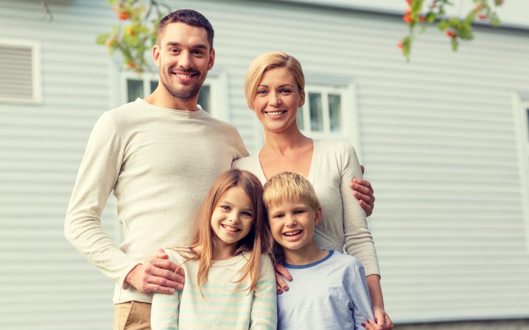 happy family in front of house outdoors